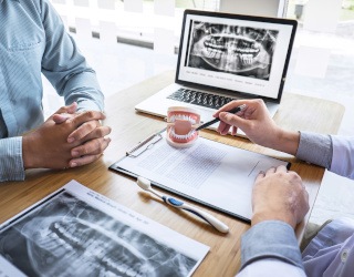 Man and woman with dental implants eating a meal