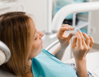 Closeup of patient holding clear aligner