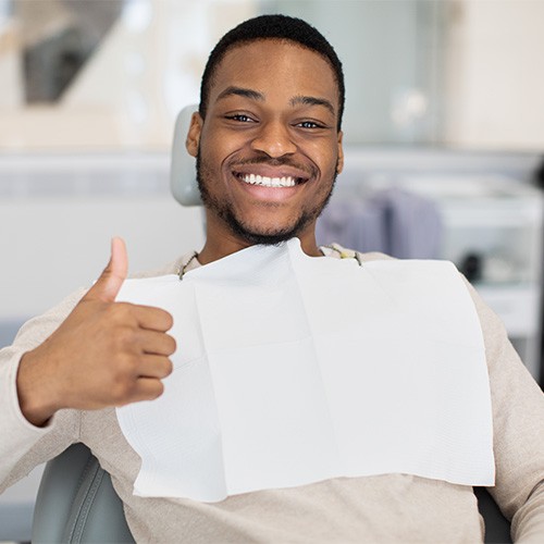 Male dental patient making thumbs up gesture